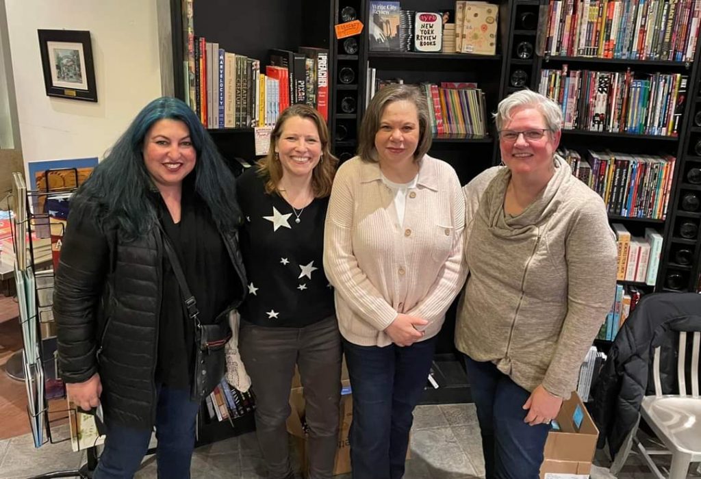 Tracy Clark, Loris Rader-Day, and guests at a book launch